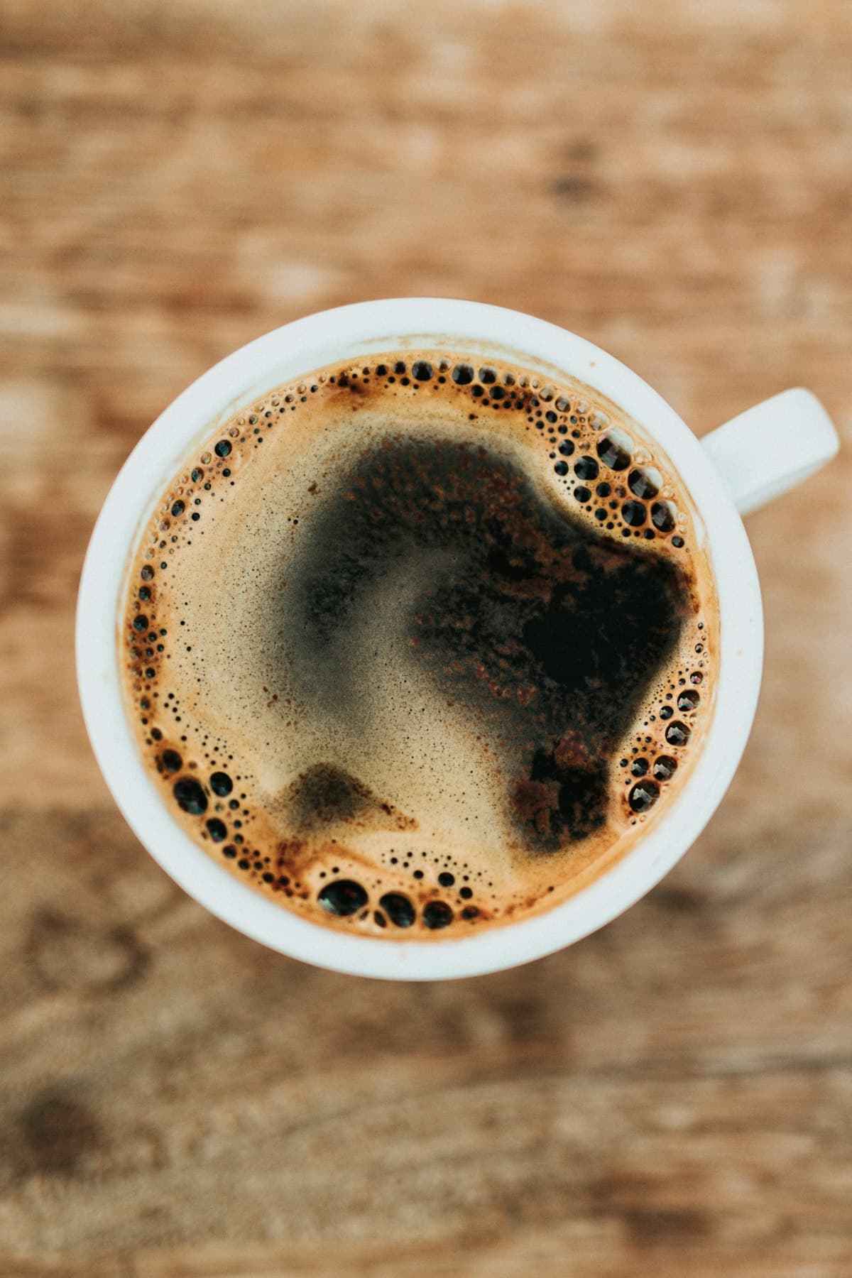 Coffee cup beside freshly baked treats