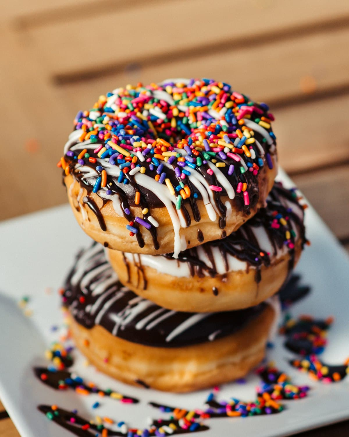 Freshly glazed mini doughnut topped with colourful sprinkles